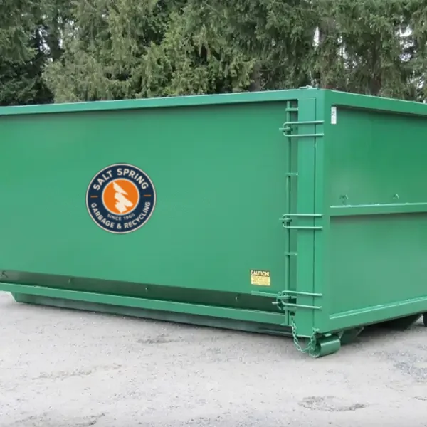 Green roll-off bin with the Salt Spring Garbage logo
