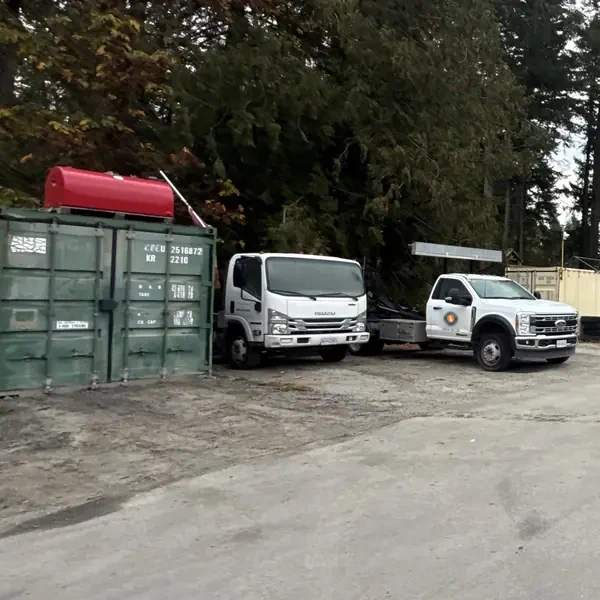 Yard entrance on Blackburn Rd with both bin trucks and the scale house