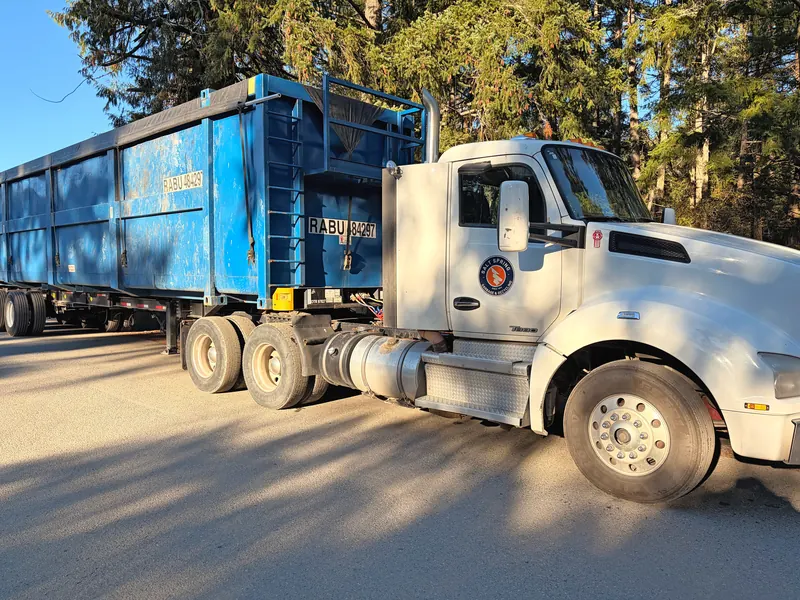 Salt Spring Garbage Kenworth tractor with a blue trailer